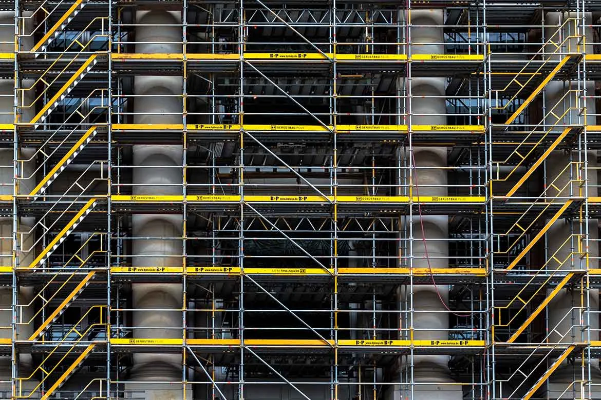 Scaffolding erected against a building facade for a traditional access survey