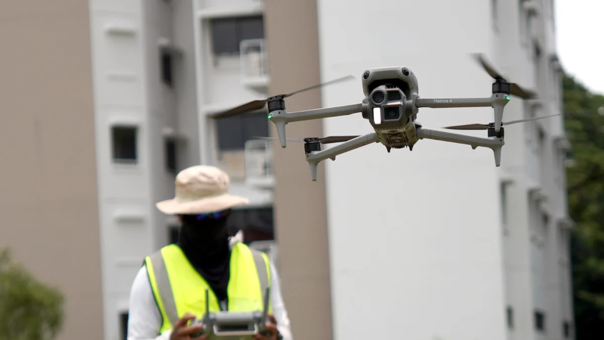 DJI Matrice drone photographing a high-rise facade at close range in Singapore